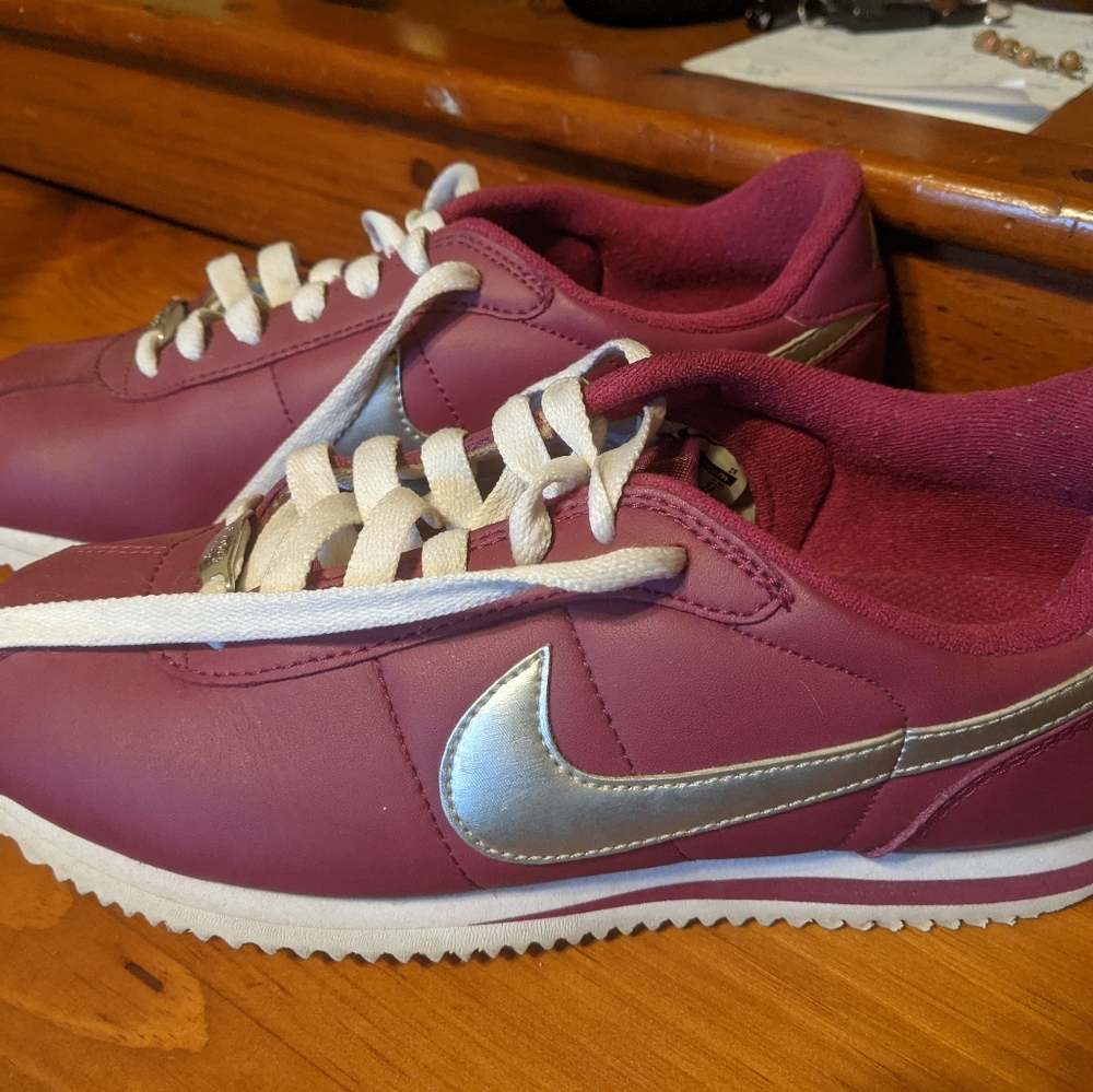 Like new Nike sneakers..these are raspberry with a metallic Nike stripe.